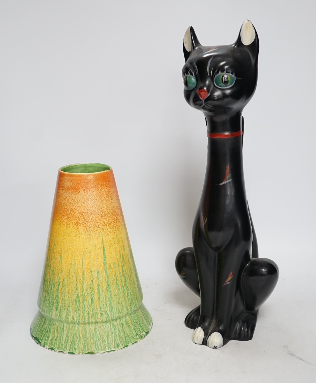 From the Studio of Fred Cuming. A 1950’s stylised ceramic cat and a Neon ware vase, largest 36cm high. Condition - cat good, vase poor